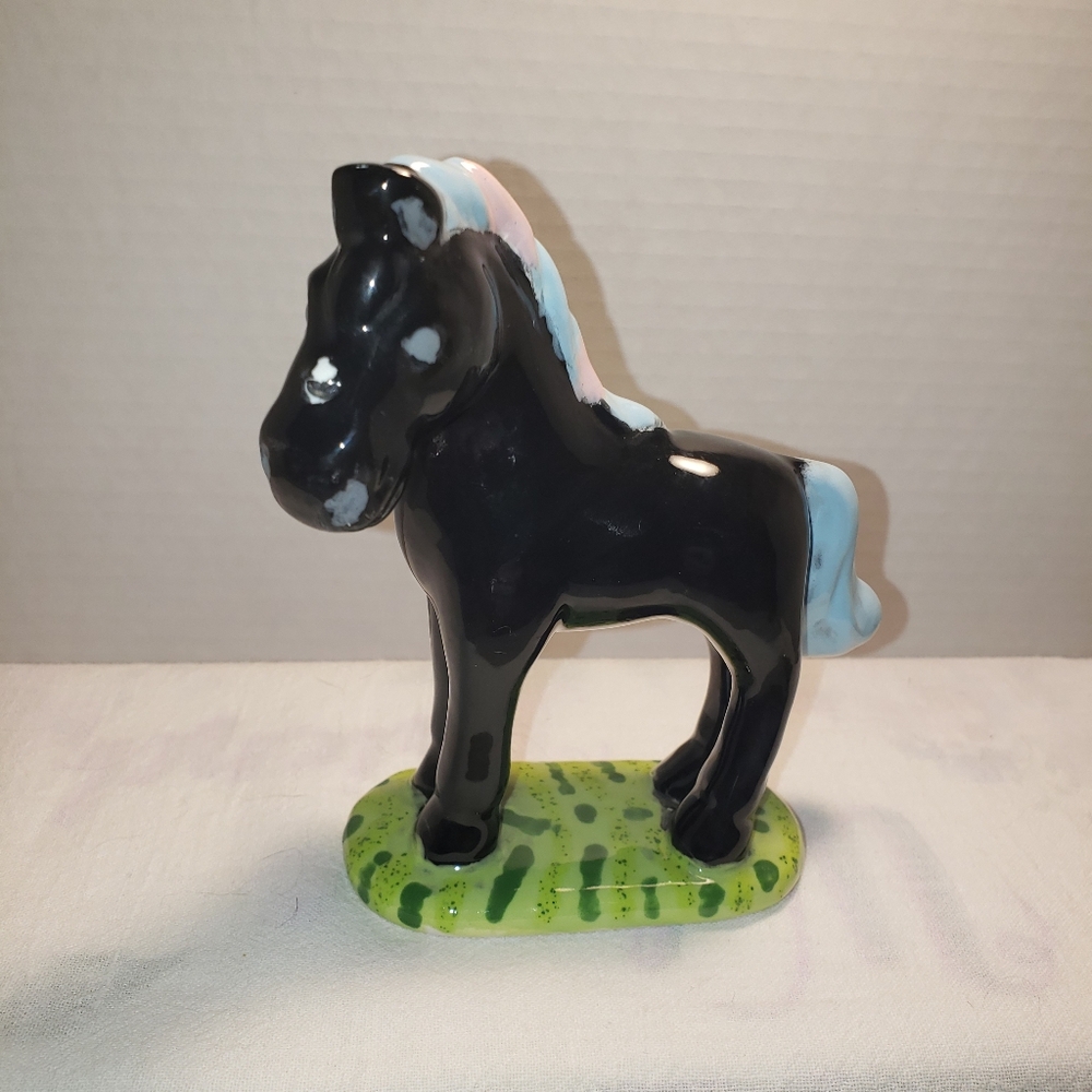 A cute little hand painted ceramic whimsical horse